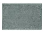 Close-up of a light green bath mat with a textured, bobble surface