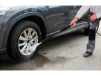 A man cleans a car wheel with a Parkside pressure washer.