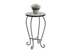 Plant stand with a mosaic top and a potted white flowering plant.