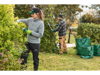 People pruning plants with PARKSIDE® tools, with garden waste bags nearby.