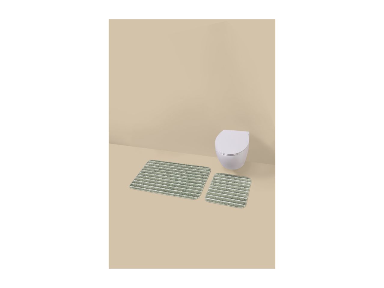 Two green striped bath mats on a light brown floor in front of a white toilet.