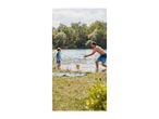 Father and son playing with a ball in the water, wearing swim shorts and a rash guard.
