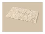 Cream-colored rectangular shag rug on a beige background.