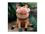 Disney's The Lion King Pumbaa plush toy sits on a wooden stump surrounded by greenery.