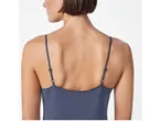 A woman wears a dark blue, thin camisole dress.