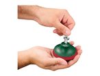 Hands assembling a green and red sanding pad with a metal screw.