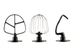 Three stand mixer attachments: a flat beater, a wire whisk, and a dough hook.