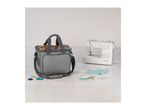 Grey sewing machine bag next to a sewing machine and sewing accessories on a table