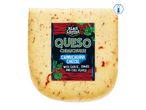 A block of Boar's Head Queso Chihuahua cheese with herbs and chili flakes.