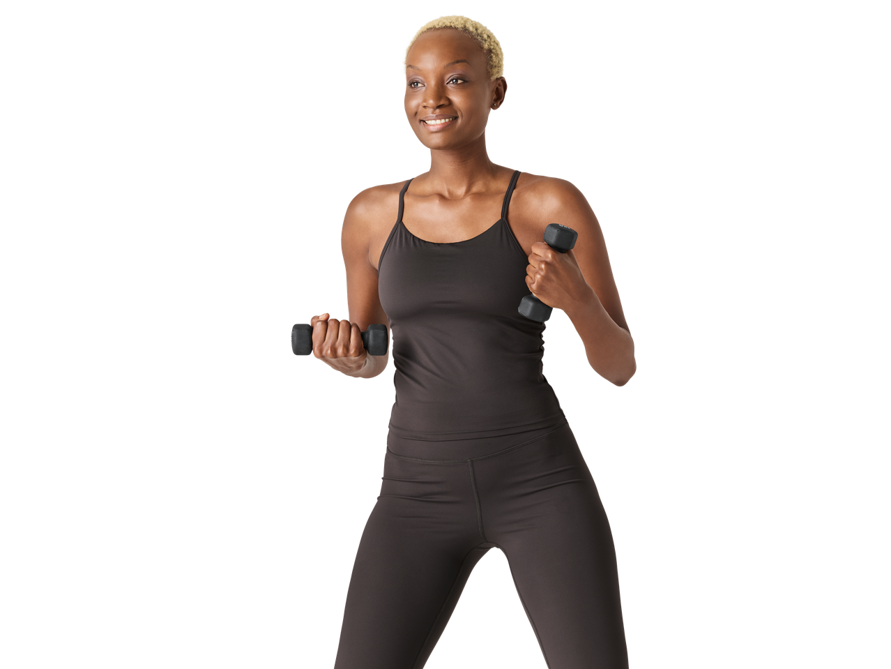 Smiling woman in CRIVIT functional tank top and leggings, holding dumbbells.