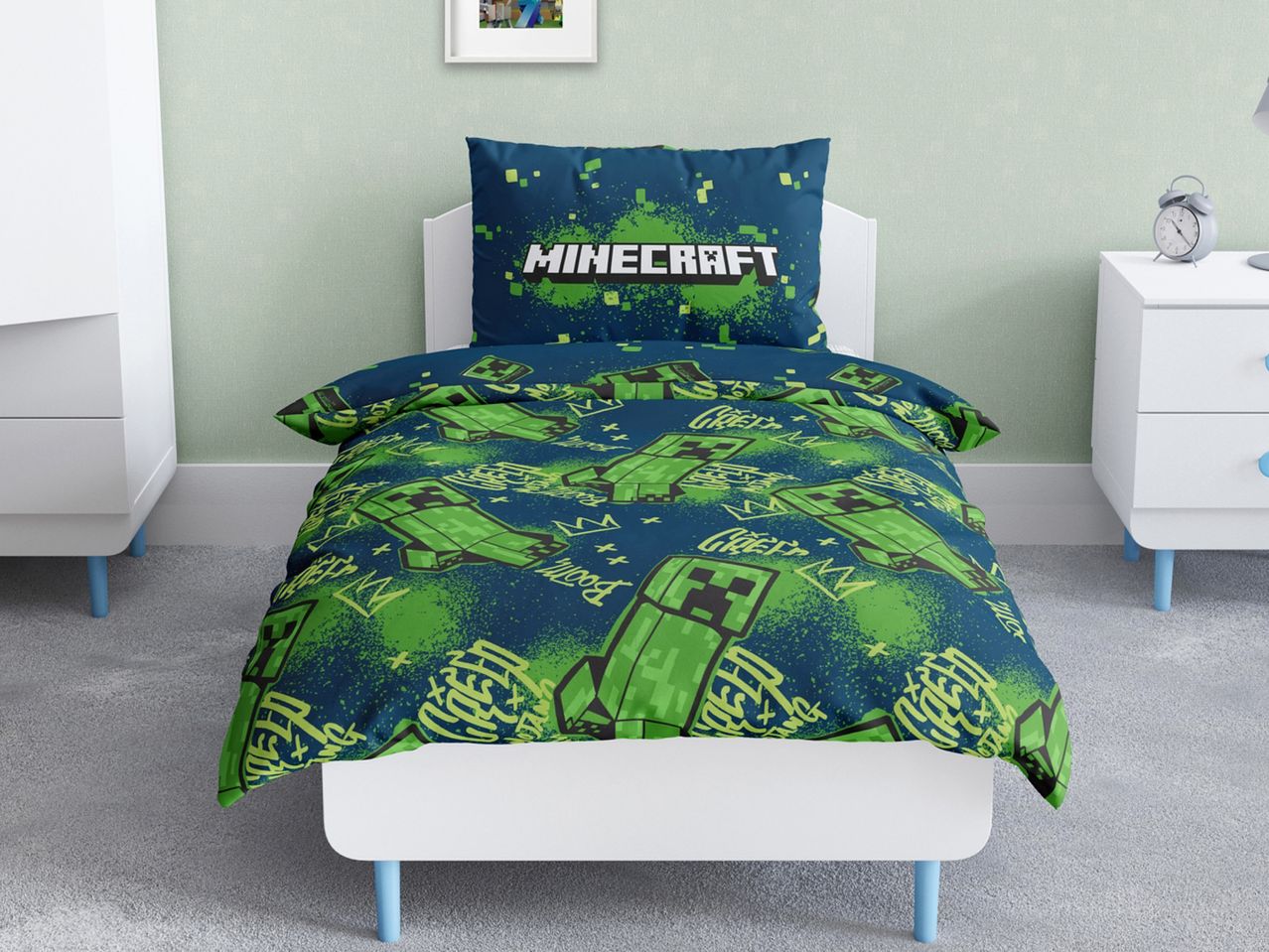 Minecraft-themed duvet cover and pillowcase set on a white bed in a child's room.