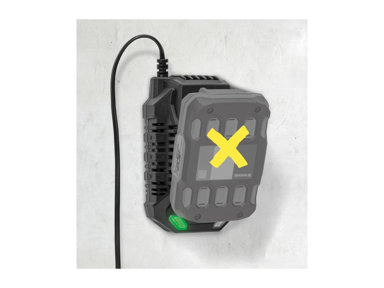 A Parkside battery charger mounted on a wall with a battery inserted, marked with a yellow X.