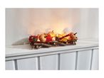 Autumnal candle holder with pumpkins, leaves, and berries on a white shelf.