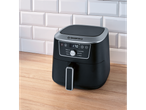 Black air fryer with a digital display on a wooden countertop in front of white subway tiles.