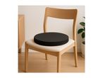 Wooden chair with a black round seat cushion in a minimalist room.