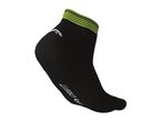 A black Crivit ankle sock with lime green stripes at the top.