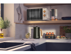 SILVERCREST® 700W Microwave in a modern kitchen with other kitchenware and food.