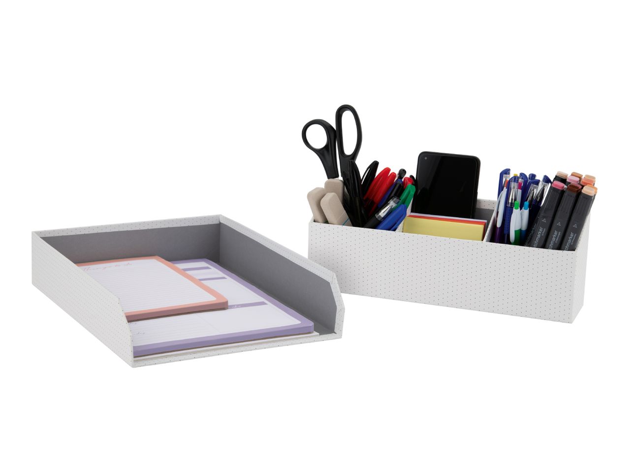 White polka dot desk organizers with notepads, pens, markers, and scissors.