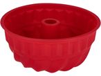 Red silicone bundt cake pan with a fluted design