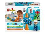 Toy box with a child playing with a blue toy motorcycle and a police officer figure.