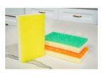 Three colorful kitchen sponges on a white countertop with cabinets in the background.