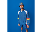 Man in blue and white tracksuit with a patterned bucket hat and shorts.