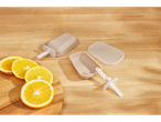 Silicone popsicle molds and sticks on a wooden surface with orange slices.
