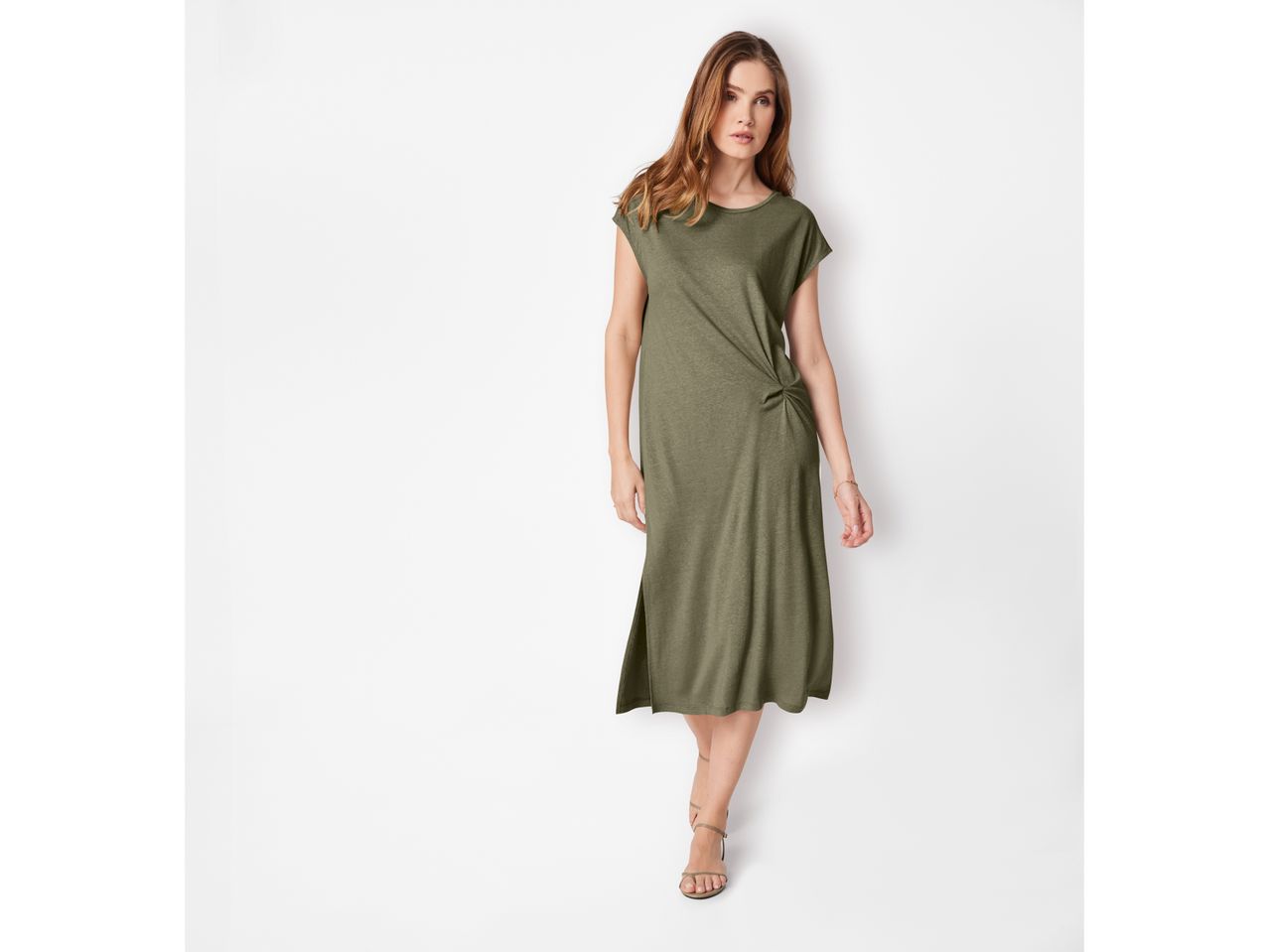 A woman models a knee-length, olive-green, knotted midi dress.