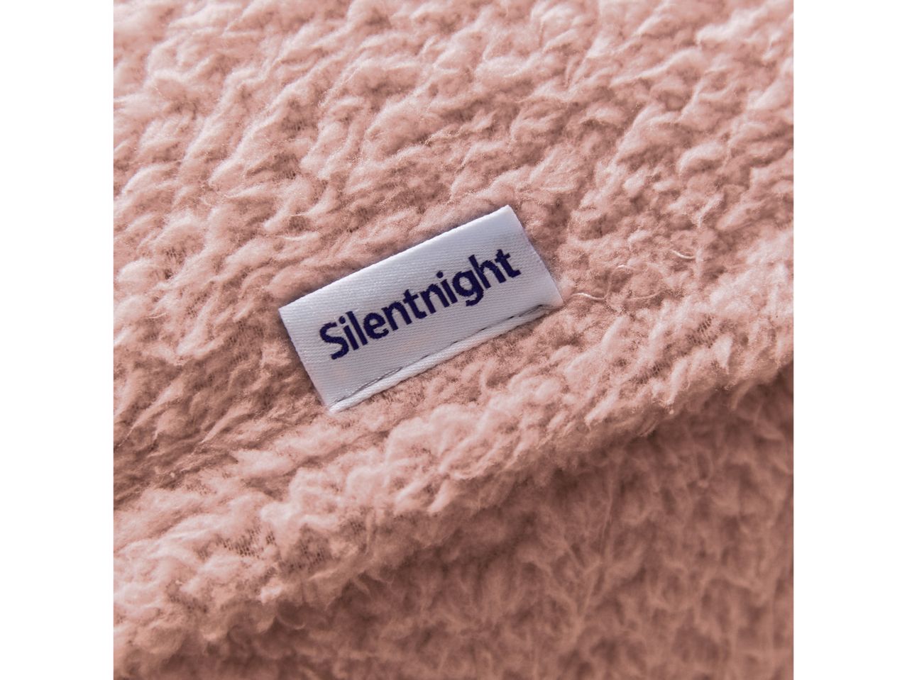 Close-up of a pink fluffy blanket with a white Silentnight brand tag.