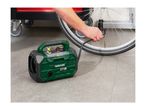 A person inflating a bicycle tire with a portable air compressor.