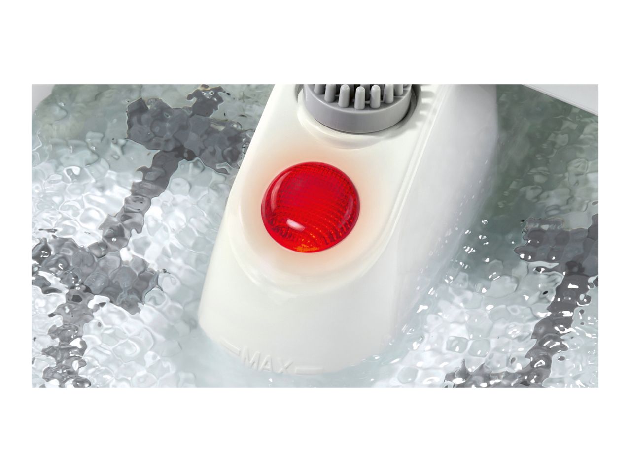 A foot spa with a red light and water at the MAX fill line.