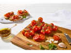 Making bruschetta with fresh tomatoes and flavored oil.