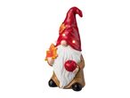 Autumn gnome figurine with a red hat, white beard, holding an apple and a leaf.