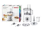 Food processor with various attachments and its packaging, featuring food preparation examples.