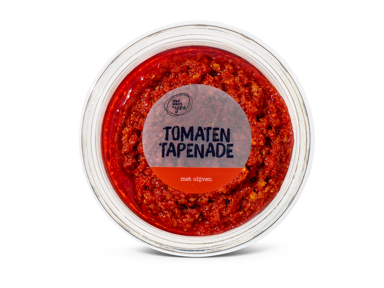 Tomatentapenade met olijven in een doorzichtige ronde verpakking, van bovenaf gezien.