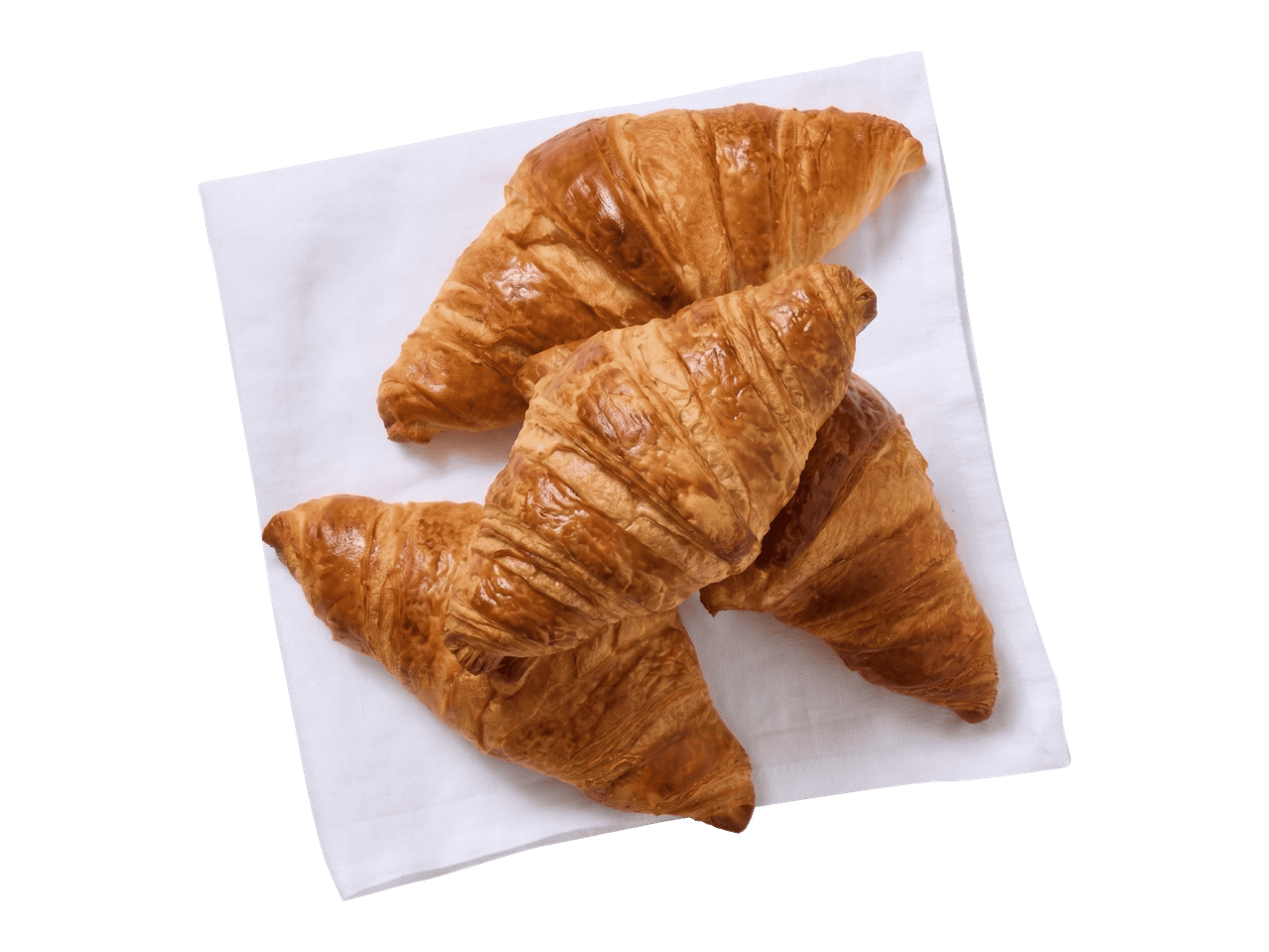 Neljä kultaisen ruskeaa croissantia valkoisella lautasliinalla.