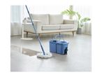 Blue spin mop and bucket cleaning a light-colored floor in a living room.