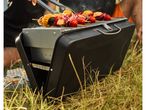 Chicken and vegetable skewers grilling on a portable Grill Master barbecue.