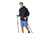 Smiling man in CRIVIT men's zip-up jacket and blue shorts, holding hiking poles.