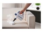 Handheld steam cleaner with a white cloth attachment cleaning a cream-colored sofa.