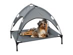 Australian Shepherd dog lying on a grey elevated pet bed with a sun canopy.