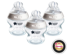 Three baby bottles with clear bodies and white tops, one with a 'Parents' award sticker.