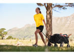 Woman pulling a wagon with sports equipment.