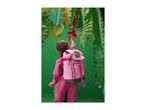 Child in pink tracksuit and backpack reaching for paper leaves and flowers.