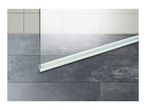 Shower screen with a water deflector strip on a dark tiled floor.