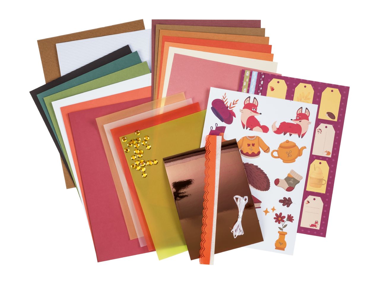 A collection of autumn-themed craft supplies including paper, stickers, and embellishments.