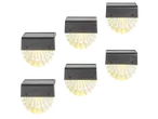 Six solar-powered LED deck lights with a shell-shaped design, emitting a warm yellow glow.