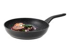 Black frying pan with a cooked steak, spinach, and red onion inside.