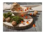 Acorn string lights, walnuts, and moss on a wooden slice, with a bowl and fabric.