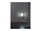 Night light with motion sensor illuminating a dark hallway.